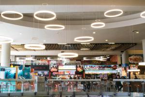 a shopping mall with a bunch of lights on the ceiling at Sky Suites - Amazing Location in La Paz