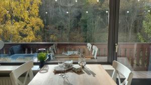 a wooden table and chairs in a room with a large window at Enjoy Winterberg in Winterberg