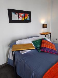 a bedroom with a bed with a wooden table on it at Casablanca Choachi in Choachí