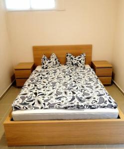 a bed with a black and white comforter and pillows at *Traum am Strand * Casa Lea * Costa Calma * in Costa Calma +30 photos