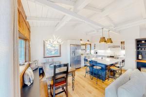 a kitchen and living room with a table and chairs at Chalet at the Base of Okemo Mountain in Ludlow
