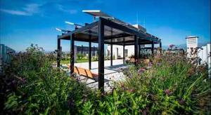 a pavilion in a park with bushes and flowers at Loft Boutique en el centro de Salta in Salta