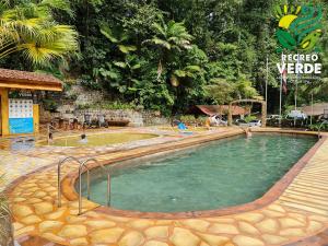 a pool at a resort with people playing in it at Recreo Verde Hot Springs & Spa in Marsella