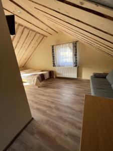 a attic room with a bed and a window at Janickowa Ostoja in Zakopane