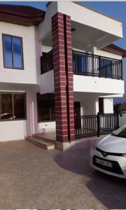 a house with a car parked in front of it at BAFFOUR STUDIO in Kumasi