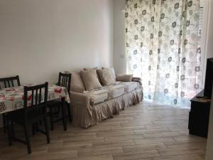 a living room with a couch and a table at Casa di Sara in Rapallo