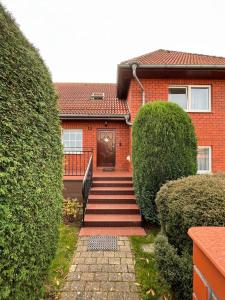 a brick house with a staircase leading to the front door at Willa Janina in Jelenia Góra