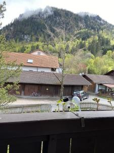 a view of a house with a fence and a mountain at Ferienhaus am Kienberg in Pfronten