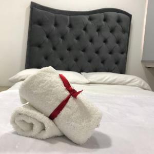 a towel animal is sitting on a bed at Hotel El Peniel in Maicao