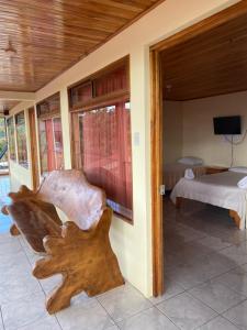 a room with a bed and a wooden piece of furniture at Hotel La Puesta Del Sol B&B in Monteverde Costa Rica