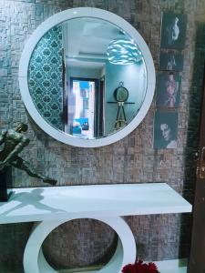 a bathroom with a mirror and a white sink at Appartement sidi rahal in Berrechid