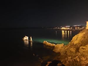 a view of a body of water at night at Makira in Terrasini