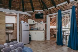 a living room with a brick wall at Cosy Cottages Guesthouse in Potchefstroom