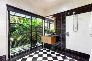 a bathroom with a black and white checkered floor at Unwind at Secret Garden Maleny 3 BR Family Home in Maleny