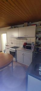 a kitchen with white cabinets and a counter top at Siegen Achenbach 4 in Siegen