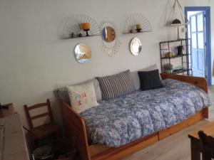 a bedroom with a bed and mirrors on the wall at El Charcón in Higuera de la Sierra