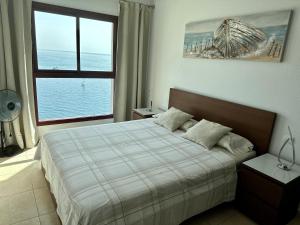 a bedroom with a bed and a large window at Su Eminencia - Luxury Apartment in Playa del Cura