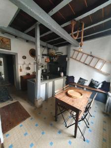 eine Küche mit einem Tisch und Stühlen im Zimmer in der Unterkunft Très belle maison chaleureuse au coeur de Mirepoix in Mirepoix