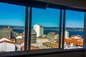a view of a city from a window at Plaza de España View with Terrace in A Coruña