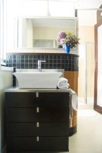a bathroom with a sink and a black cabinet at Plaza de España View with Terrace in A Coruña