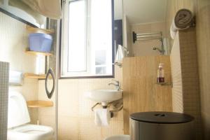 a bathroom with a sink and a toilet and a window at Plaza de España View with Terrace in A Coruña