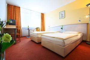 
Ein Bett oder Betten in einem Zimmer der Unterkunft Panorama Inn Hotel
