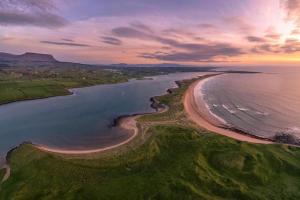 an aerial view of a beach at sunset at Luxury Wild Atlantic Way Retreat in Grange
