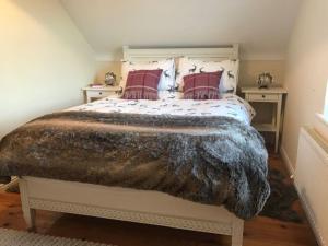 a bedroom with a large bed with red pillows at Luxury Wild Atlantic Way Retreat in Grange