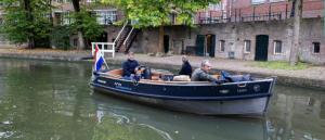 a group of people sitting in a boat in the water at Hotel Oudegracht in Utrecht
