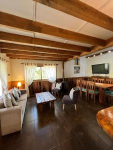 a living room with a couch and a table at Cabañas Alto Bosque in Pucón