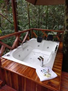 a bath tub sitting on top of a wooden deck at ECO HOTEL RIO DE ORO in San Rafael