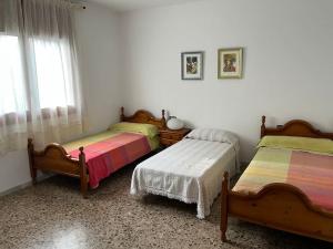 Posteľ alebo postele v izbe v ubytovaní Casa la Pineda Salou, playa y Port Aventura