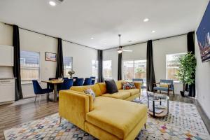 a living room with a yellow couch and a table at Family stay! Near Downtown, Coffee bar, King bed in San Antonio