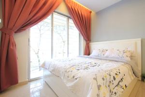 a bedroom with a bed and a large window at Lovage Stay Melaka in Melaka