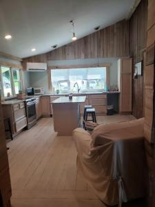 a kitchen with a couch and a table in it at Red River Gorge Farmhouse 50 Acres in Stanton