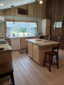 a kitchen with a large island in the middle of it at Red River Gorge Farmhouse 50 Acres in Stanton