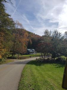 a house on the side of a road with trees at Red River Gorge Farmhouse 50 Acres in Stanton