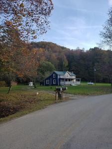 a house on the side of a road next to a street at Red River Gorge Farmhouse 50 Acres in Stanton