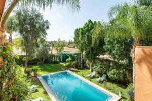 an image of a swimming pool in a yard with trees at Villa près de golfs in Marrakech