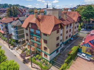 an overhead view of a large house with red roof at Palladio 304 - Gramado 400 metros Rua Coberta in Gramado