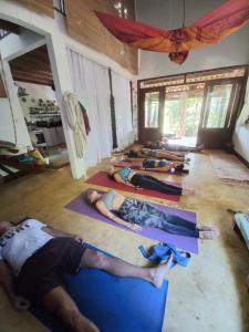 a group of people laying on the floor in a yoga class at Sitio Namaste in Itacaré +18 photos