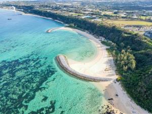 an aerial view of a beach and the ocean at Bunzo Rezort 今帰仁 in Shushi