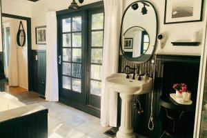 a bathroom with a sink and a mirror at 100 Mile View-Fire Pit, Romantic, Peaceful, Private in Crestline