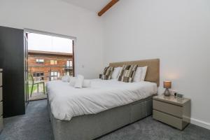 a bedroom with a large bed and a large window at Sea Breeze 17 Gannel in Truro