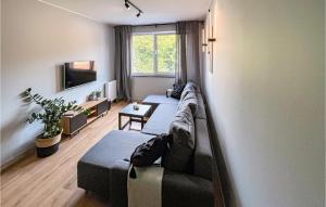 a living room with a couch and a tv at 1 Bedroom Stunning Apartment In Gdansk in Gdańsk