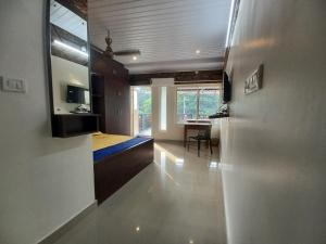 a room with a bedroom with a bed and a desk at JEENA MOTEL in Kollam