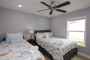 a bedroom with two beds and a ceiling fan at Mallard in Rockport