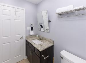 a bathroom with a sink and a mirror and a toilet at Mallard in Rockport +11 photos