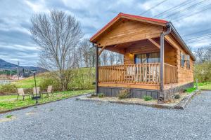 a log cabin with a porch and a deck at The Homeplace in Sevierville