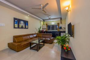 a living room with a couch and a table at 4bhk Stunning Apartment with Pool 2bhkX2 in Old Goa